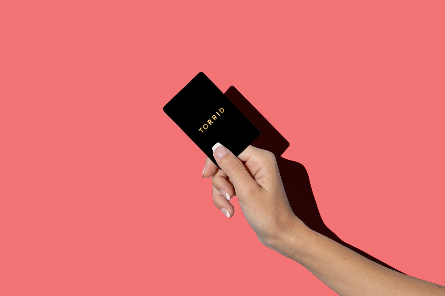 A person holding a torrid card