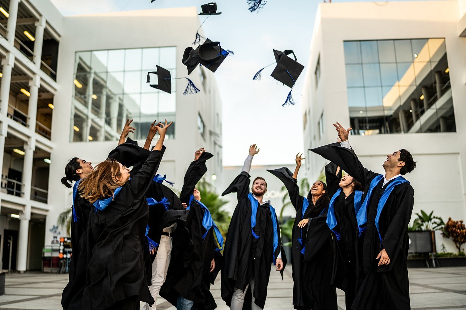 Students graduating and throwing their caps