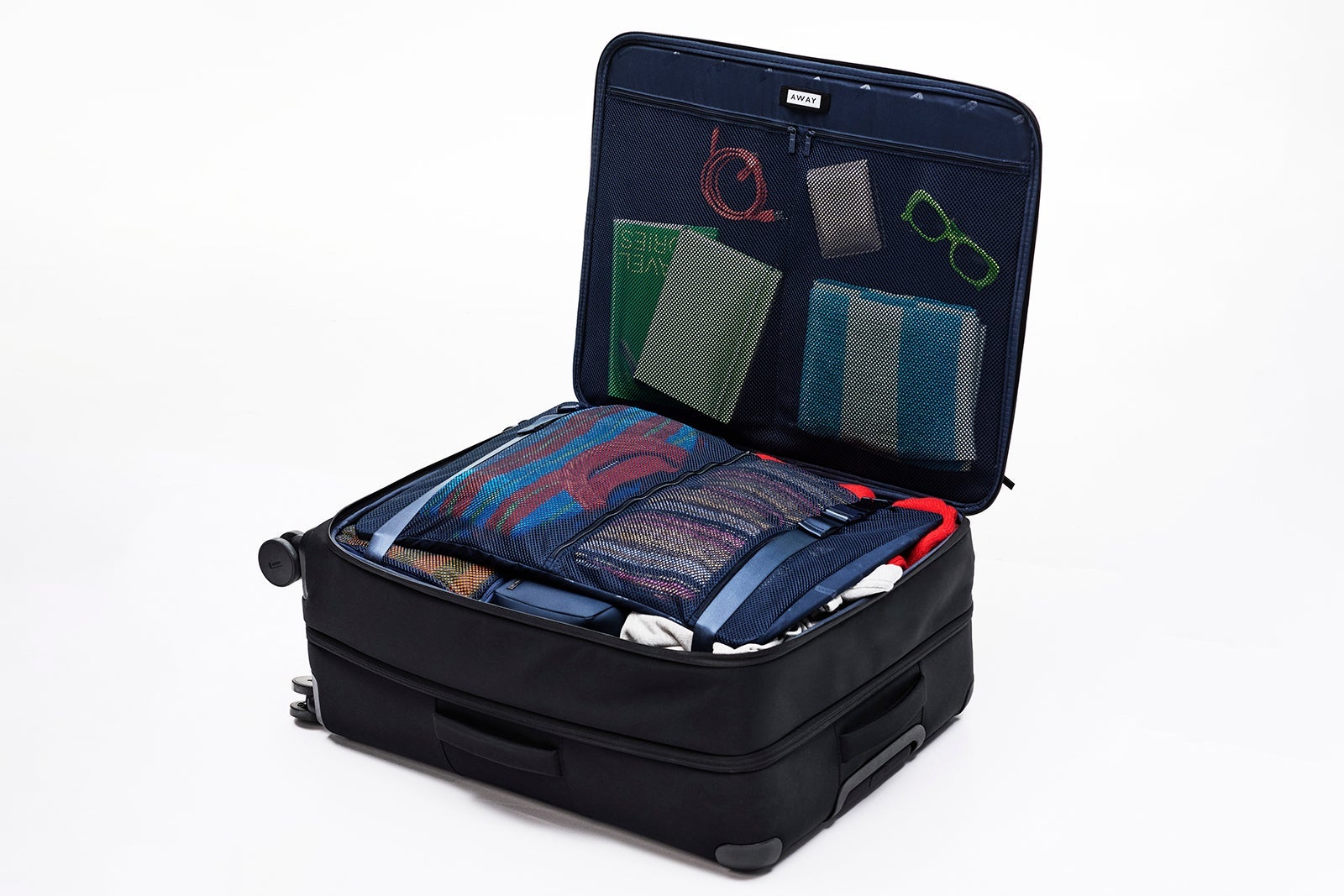 A softsided away suitcase full of clothes