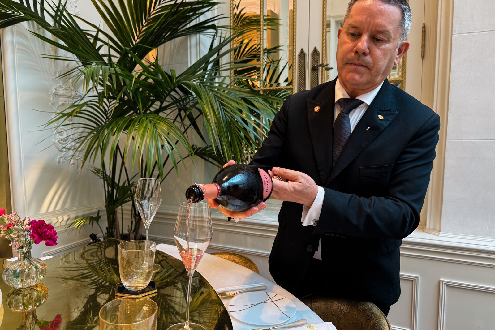 A man pouring a glass of rosé at the Mandarin Oriental Ritz, Madrid