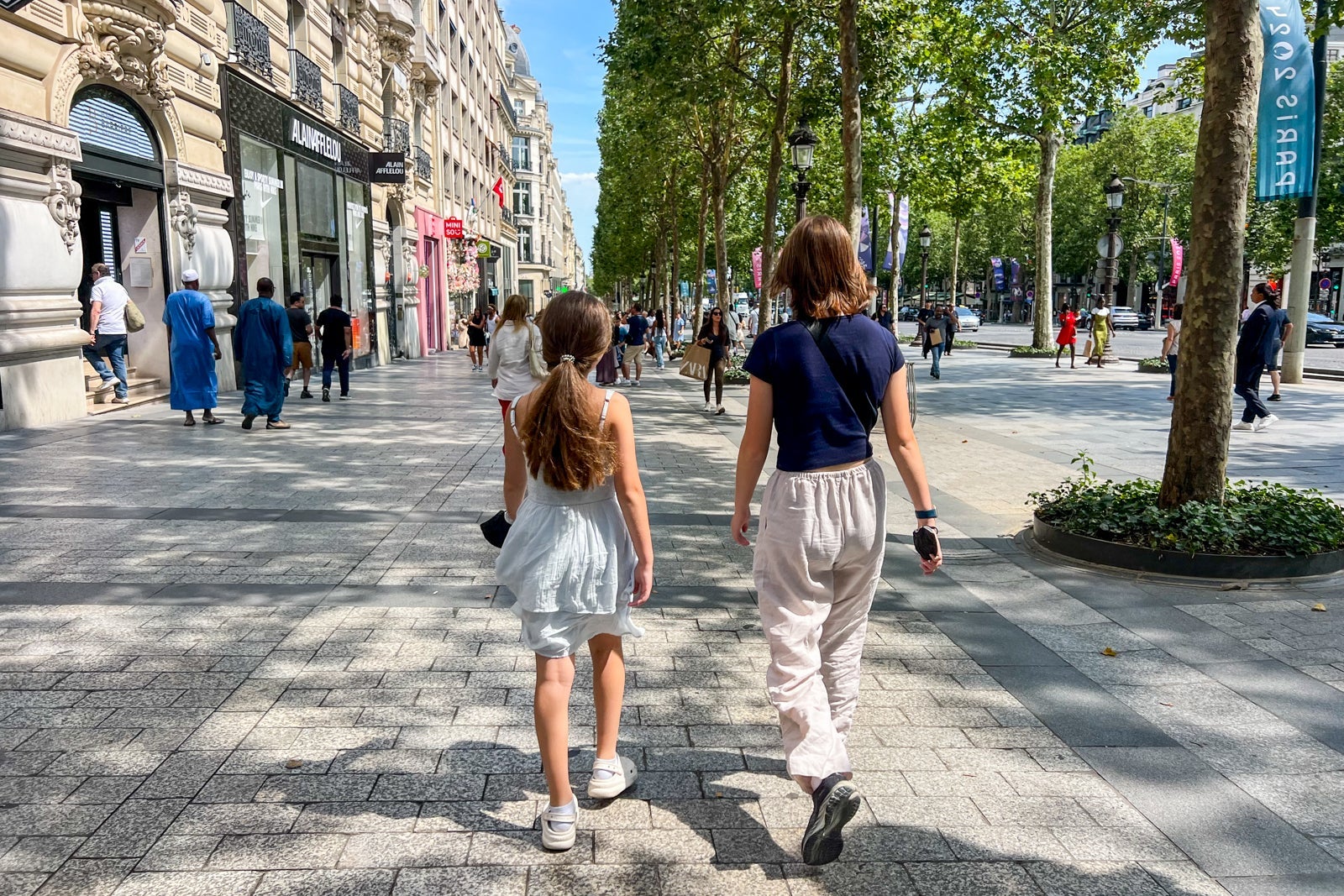 Two children walking down a European street
