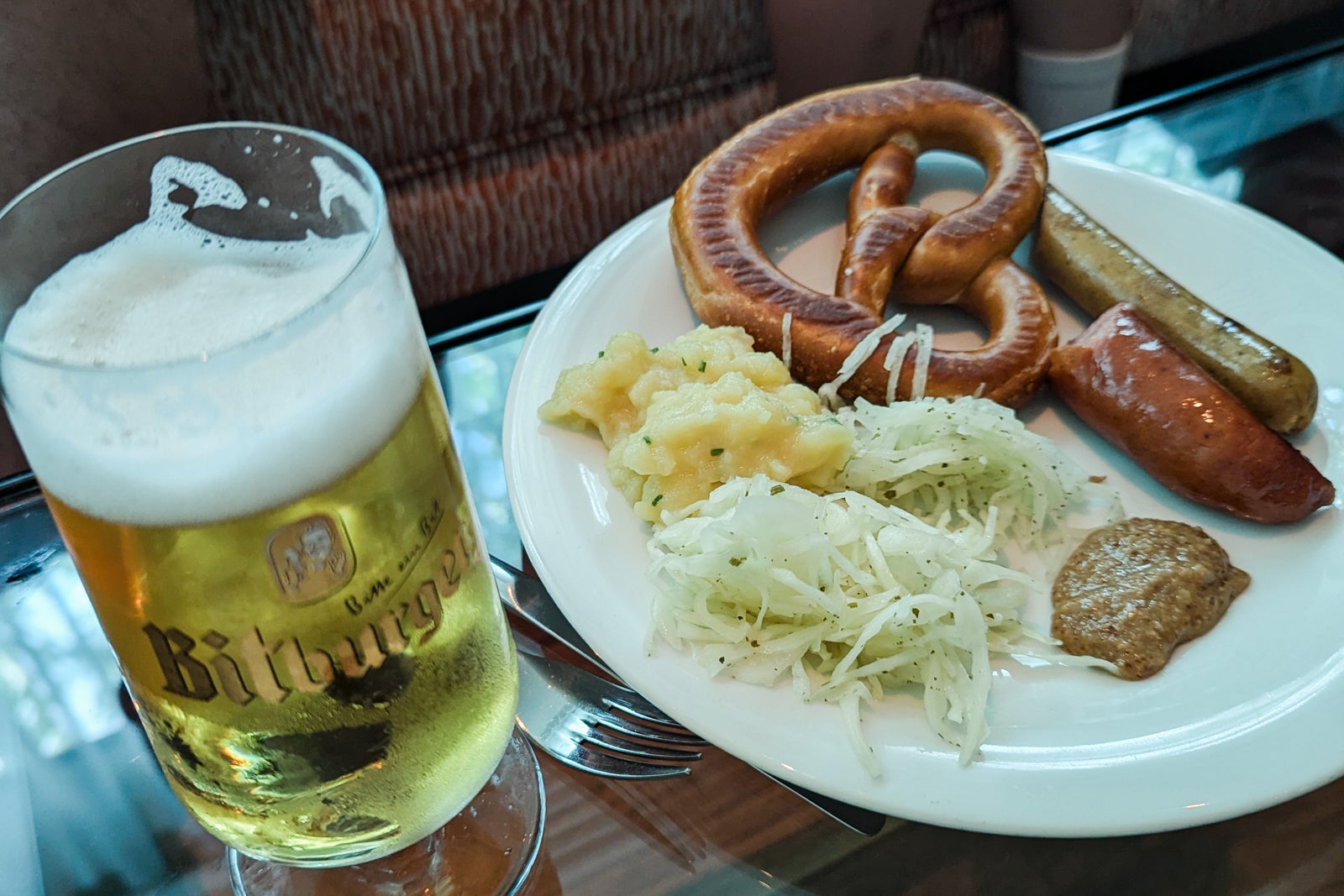 Beer with pretzel and German sausage
