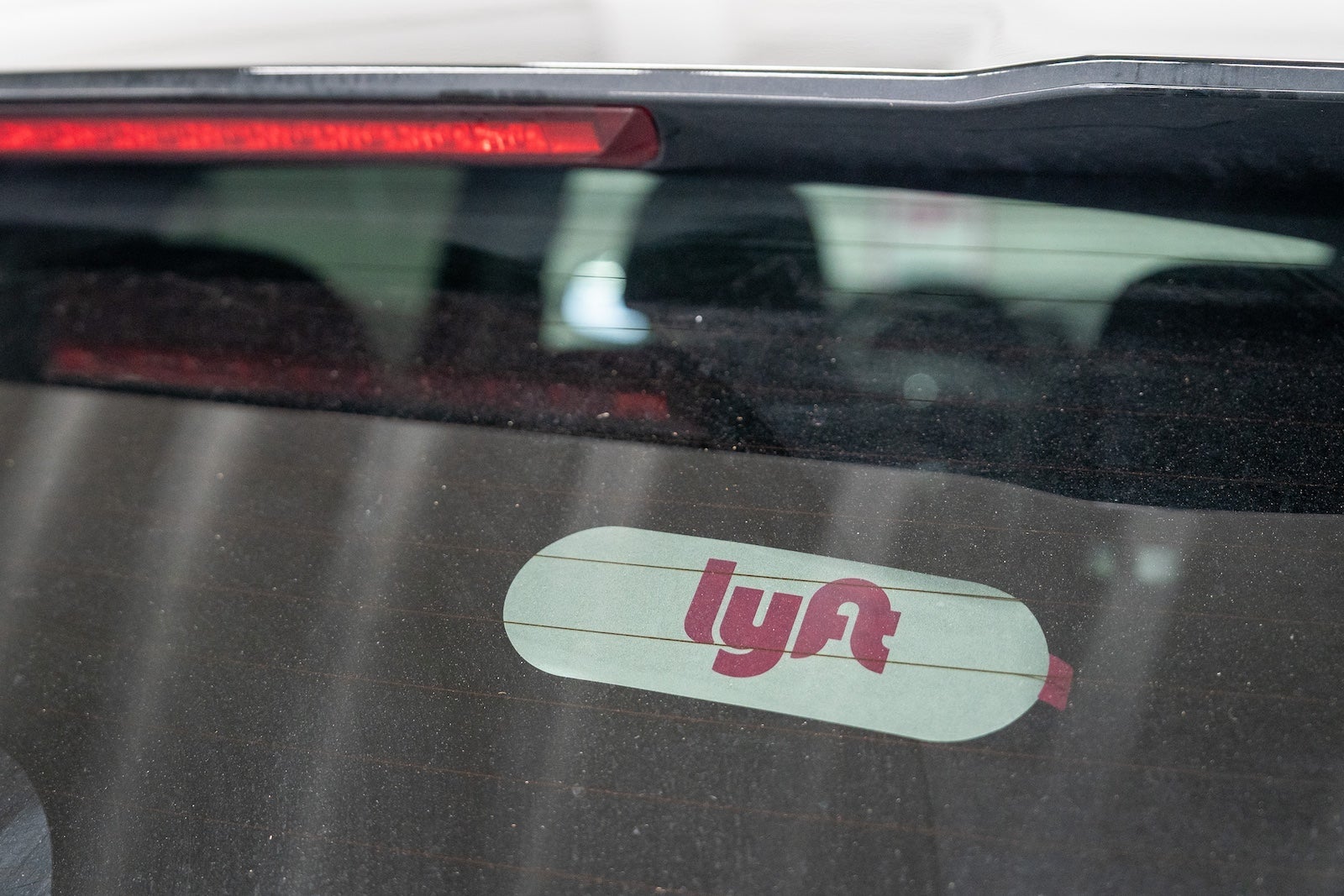 Lyft sticker on the back mirror of a car