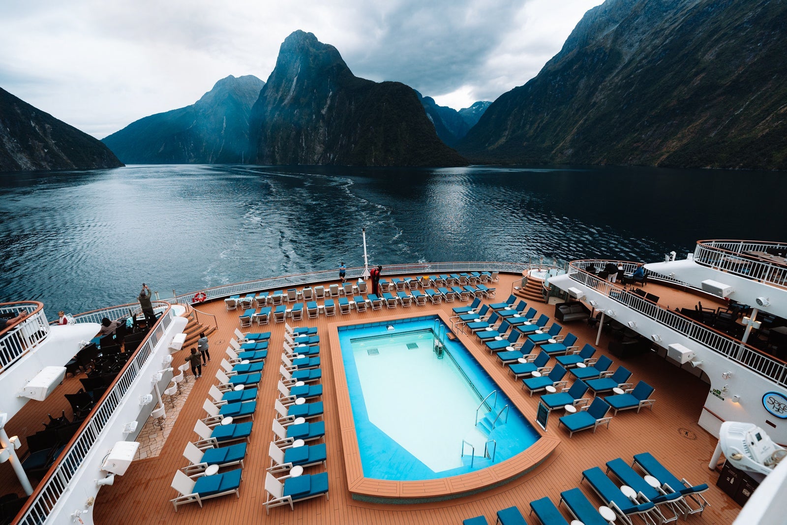 Cruise ship aft pool with mountains behind it