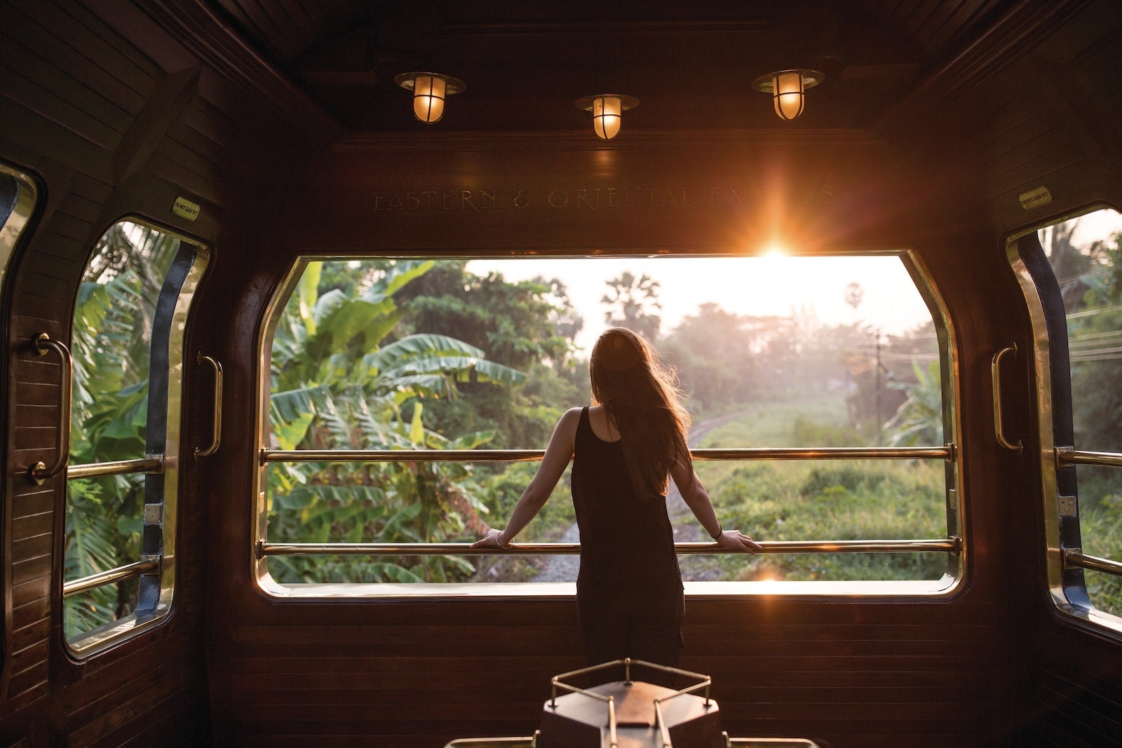 A woman enjoying the view on a Belmond train
