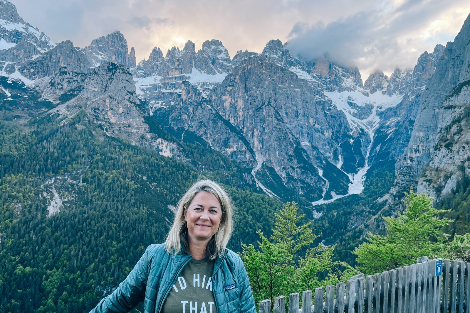 Woman posing in front of a view of the Dolomites
