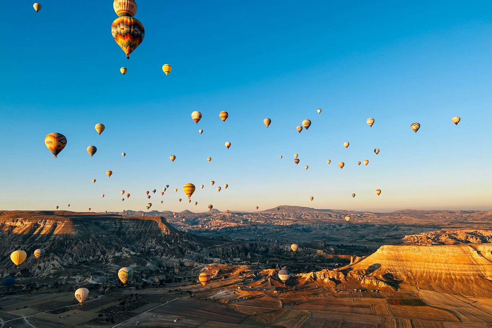 view of Cappadocia and hot air balloons at sunrise