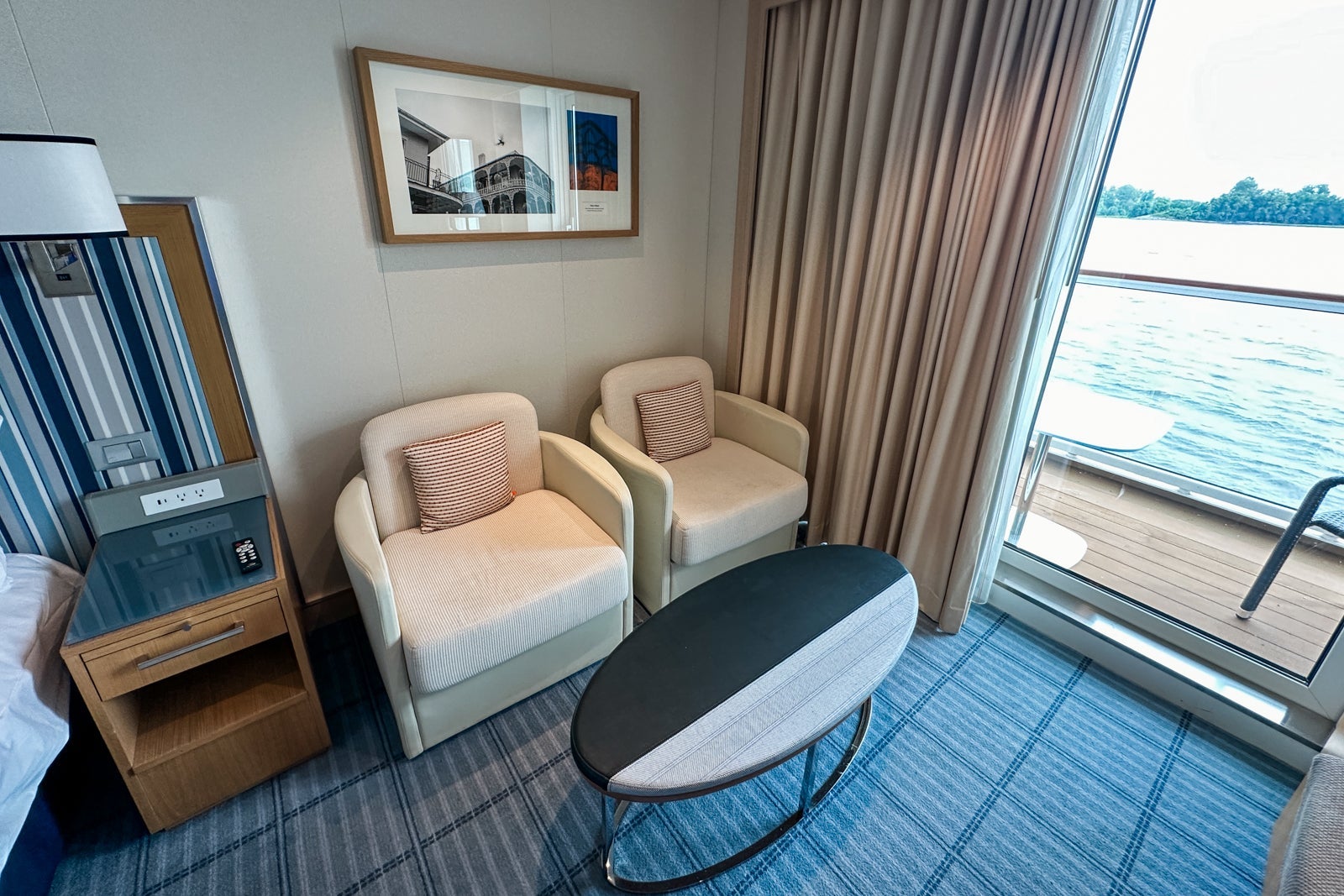 Two plush sitting chairs and a long, oval coffee table