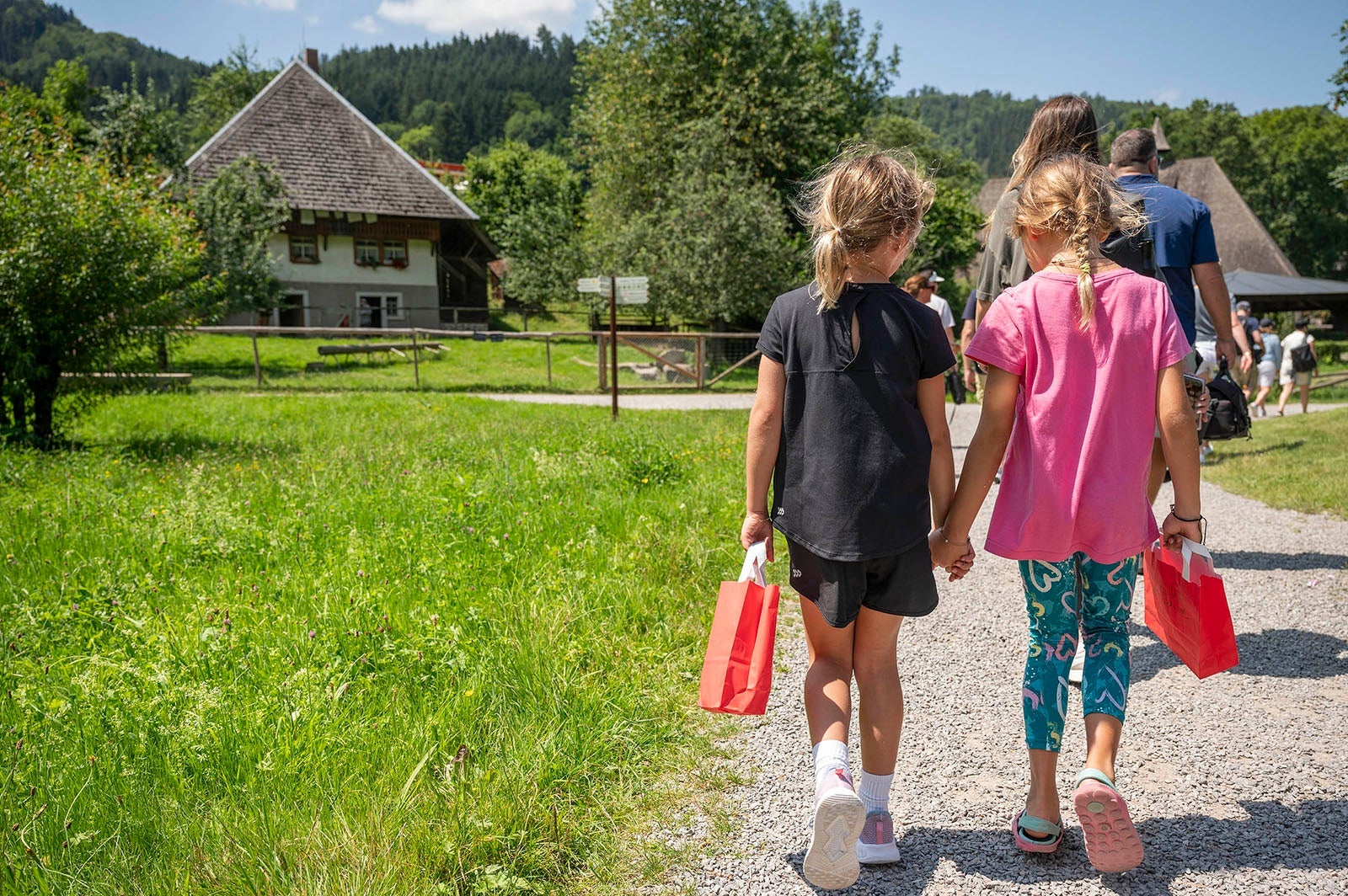 Two young girls walking hand in hand