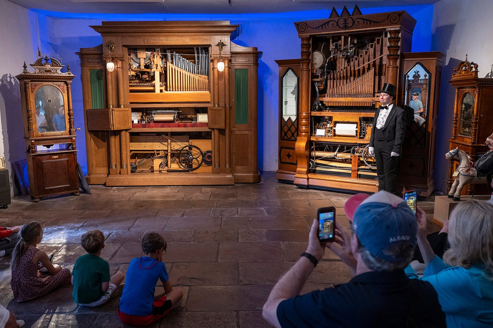 Tuxedoed guide at mechanical music museum