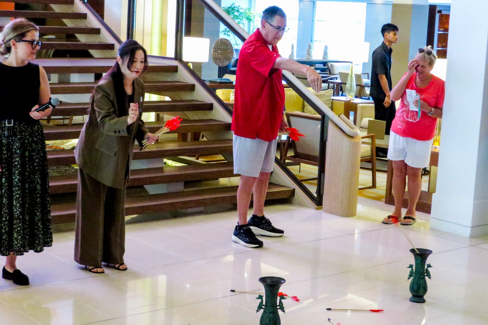 Cruise passengers play a game of Chinese Pitch-Pot on a ship