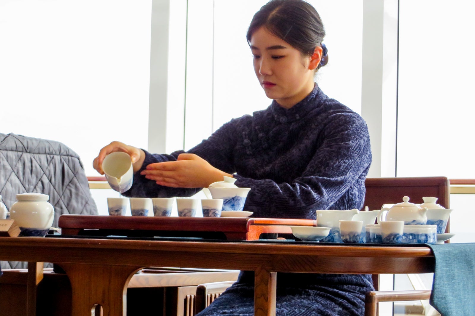 A woman performs a traditional Chinese tea ceremony