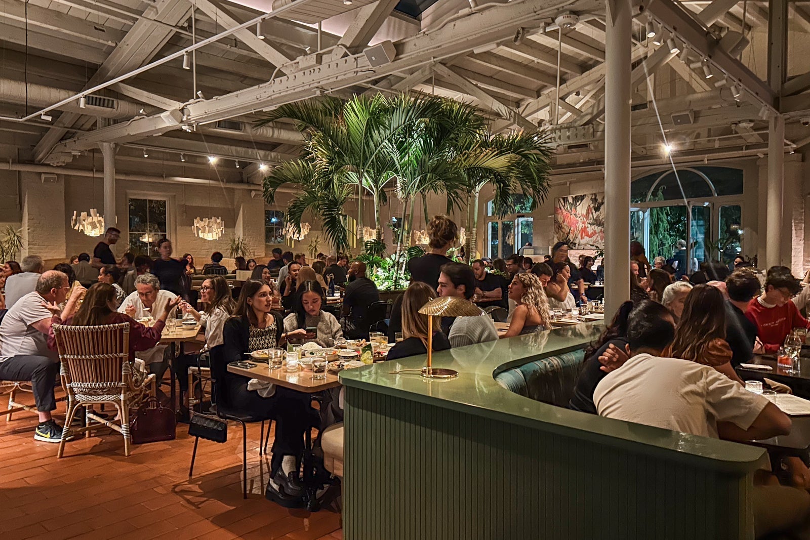 The large dining room at Kalaya is centered around a palm tree.