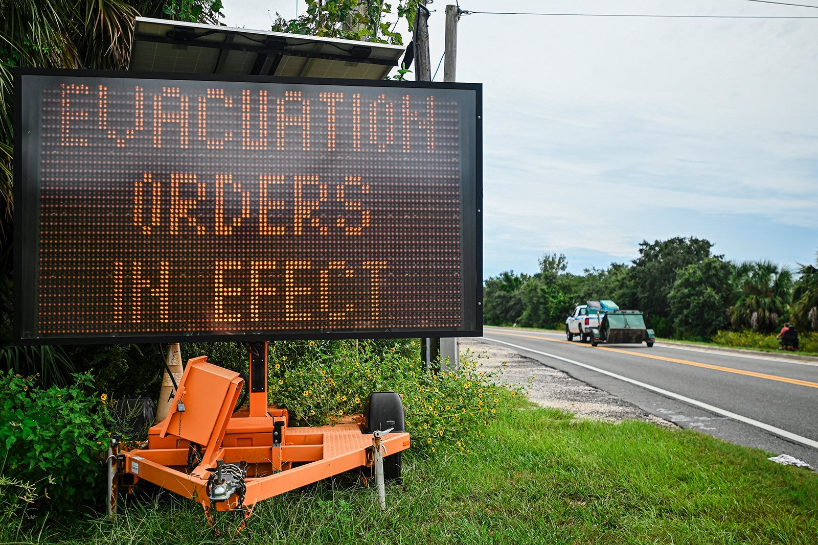 A sign displays evacuation orders as preparations are made for the arrival of Hurricane Helene, in Cedar Key, Florida on September 25, 2024. Thousands of residents on Wednesday began evacuating parts of coastal Florida as the US state braces for Hurricane Helene, forecast to barrel ashore as a powerful, potentially deadly storm. Helene strengthened into a hurricane mid-morning in the Gulf of Mexico and is "expected to bring life-threatening storm surge, damaging winds, and flooding rains to a large portion of Florida and the Southeastern United States," the National Hurricane Center in Miami said in its latest bulletin. MIGUEL J. RODRIGUEZ CARRILLO/AFP/GETTY IMAGES