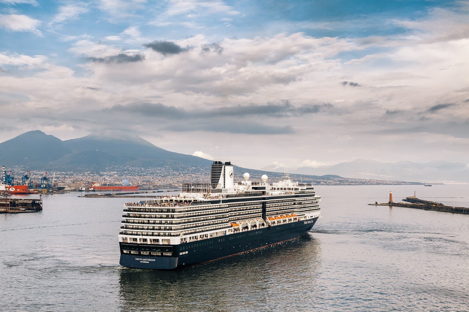 Holland America's Nieuw Amsterdam cruise ship navigating out of Naples harbor.