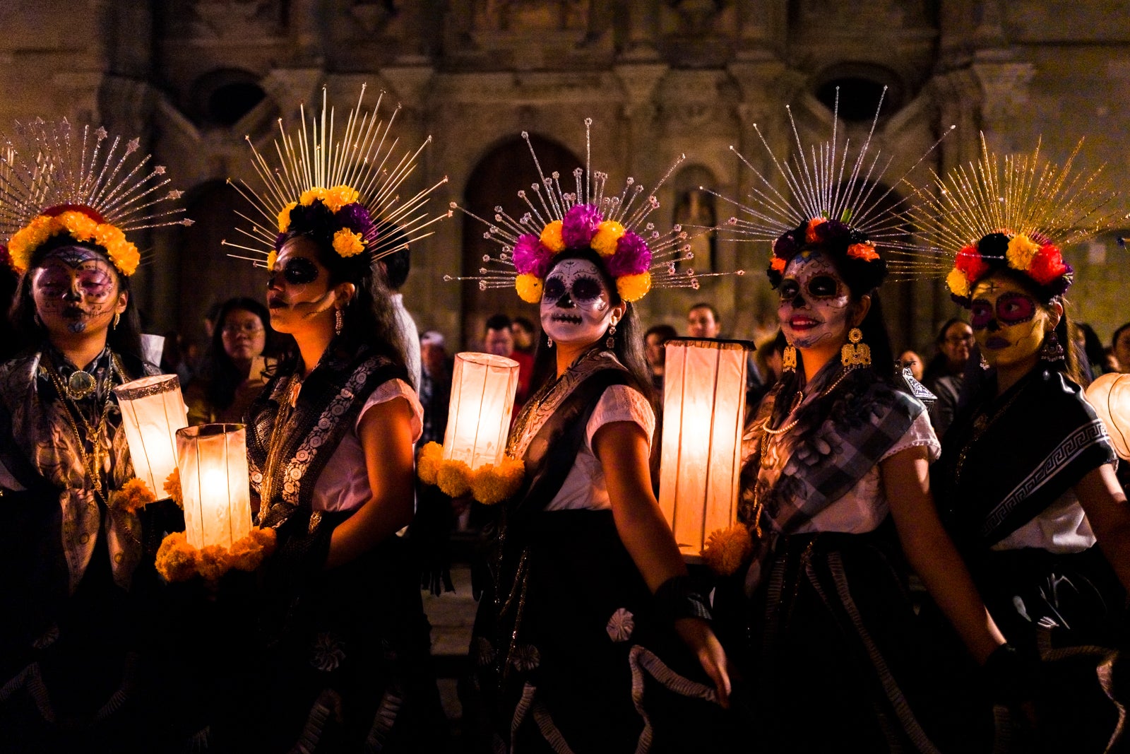 OAXACA, MEXICO - OCTOBER 31: Young Mexican women, dressed as La Catrina, a Mexican pop culture icon representing the Death, take part in the Day Of The Dead celebrations on October 31, 2019 in Oaxaca, Mexico. Day Of The Dead, a religious holiday combining the death veneration rituals of Pre-Hispanic cultures with the Catholic practice, is widely celebrated throughout all of Mexico. Based on the belief that the souls of the departed may come back to this world on that day, people gather praying or joyfully eating, drinking and playing music, to remember friends or family members who have died and to support their souls on the spiritual journey. (Photo by Jan Sochor/Getty Images)