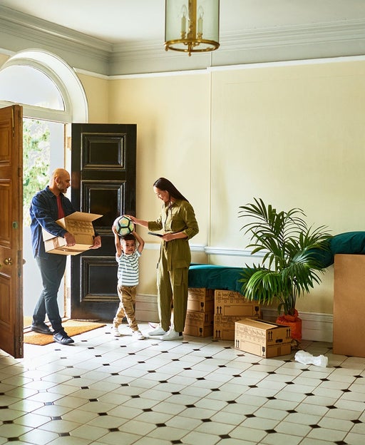 Family in hallway of new house on moving day