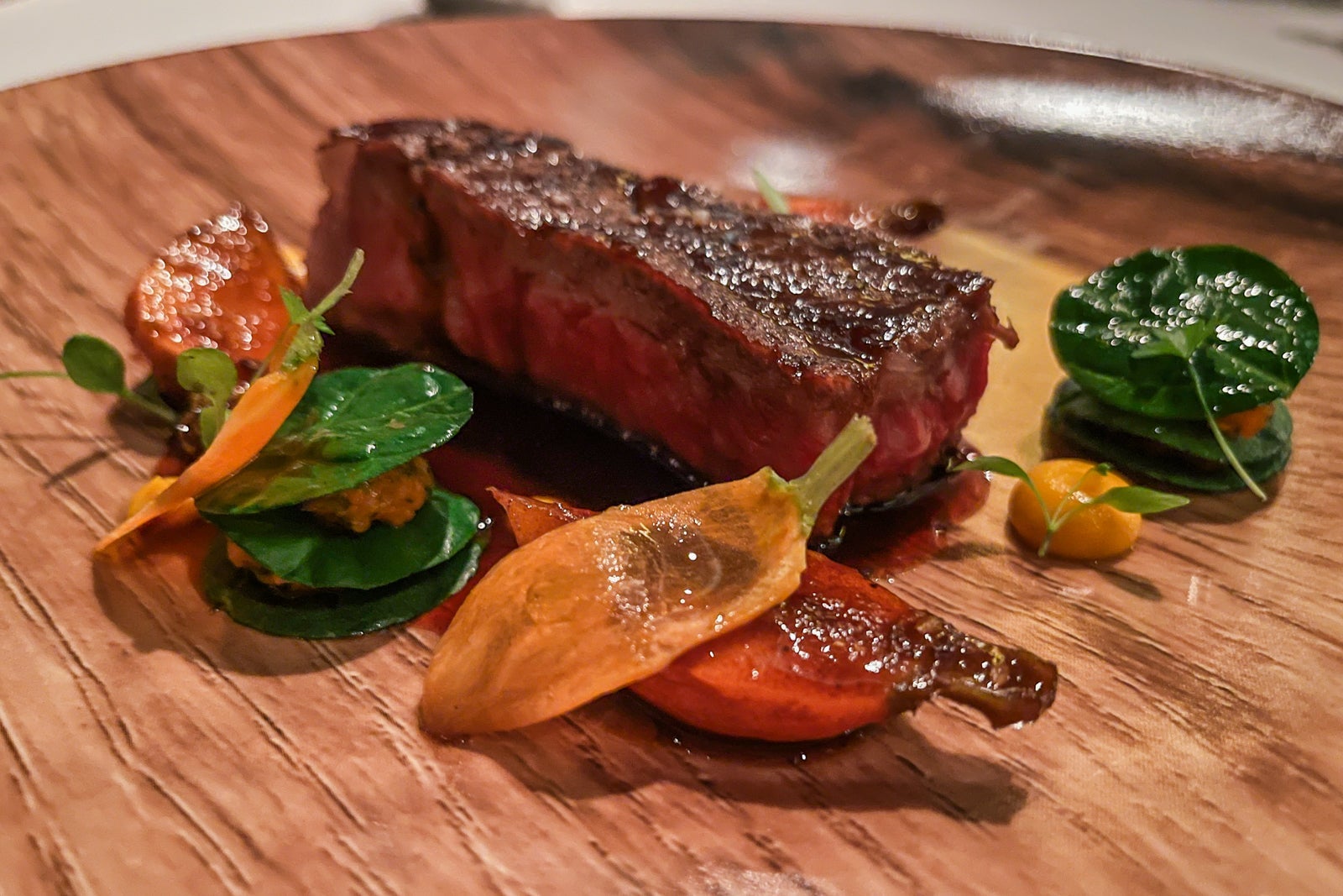 Kobe beef on wooden board with peppers