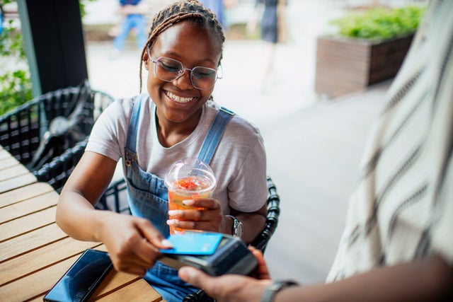 Woman using a credit card to pay