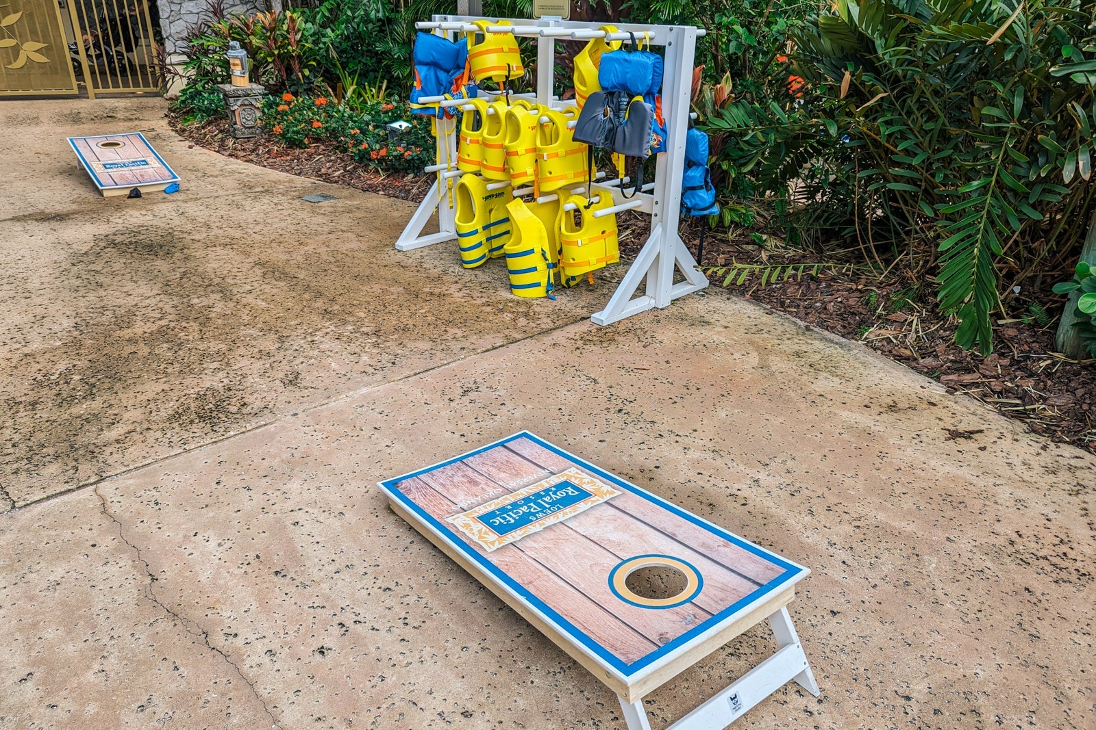 bean bag toss and life jackets by pool
