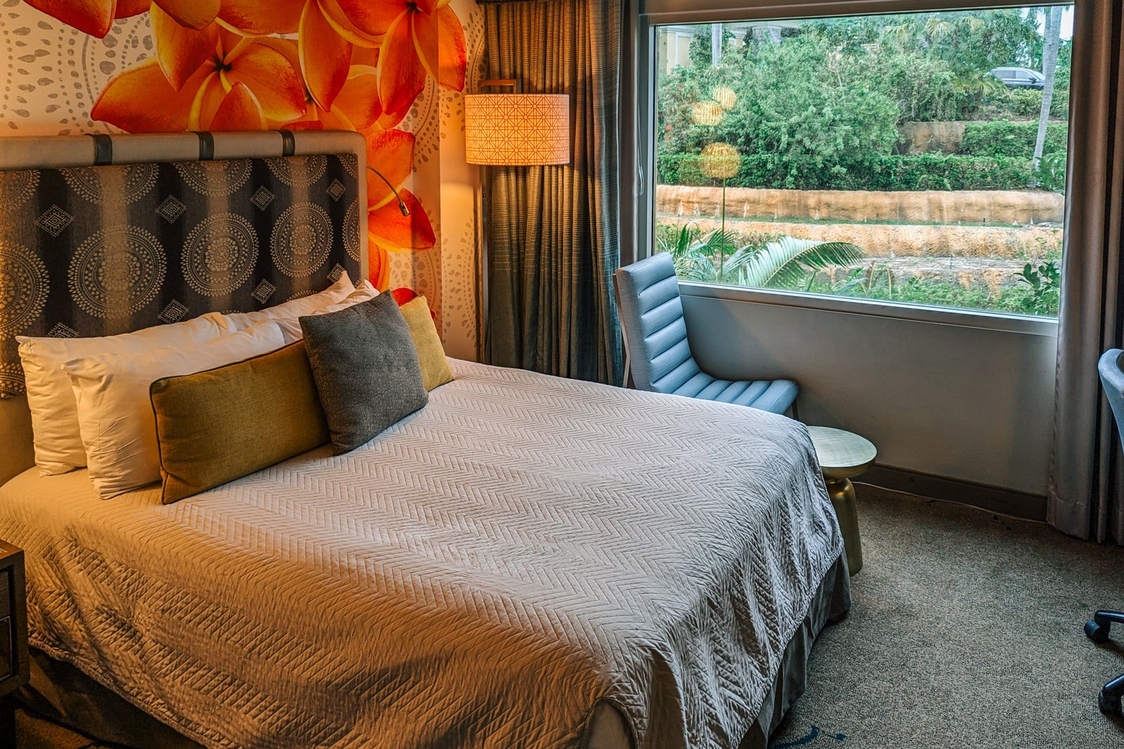 Hotel room bed with extra chair by window