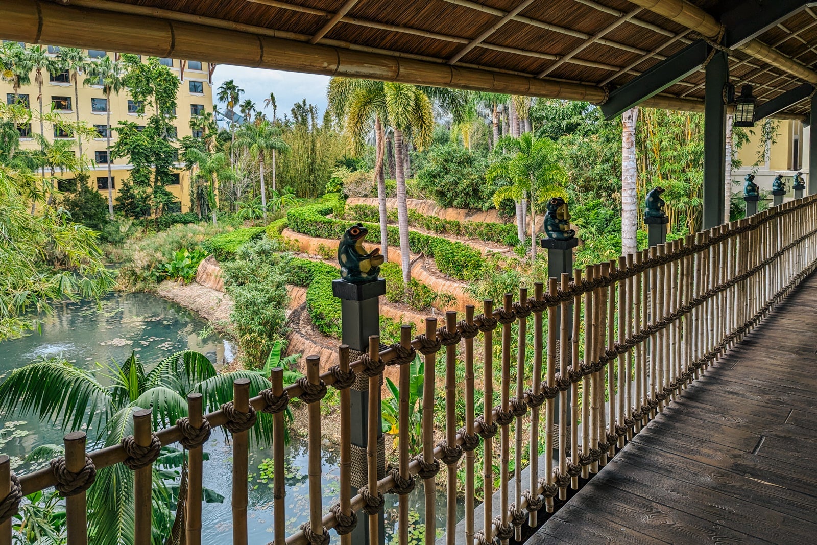 Hotel entrance walkway with frogs on the railing