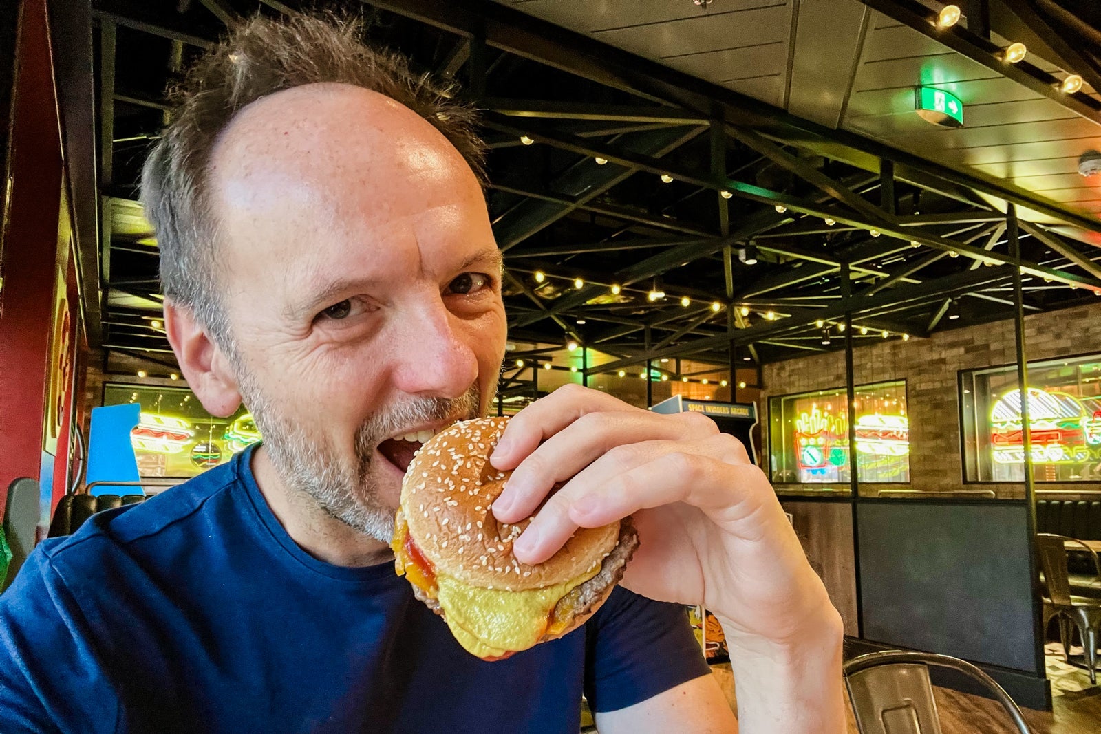 Biting into a burger at Pizza & Burger