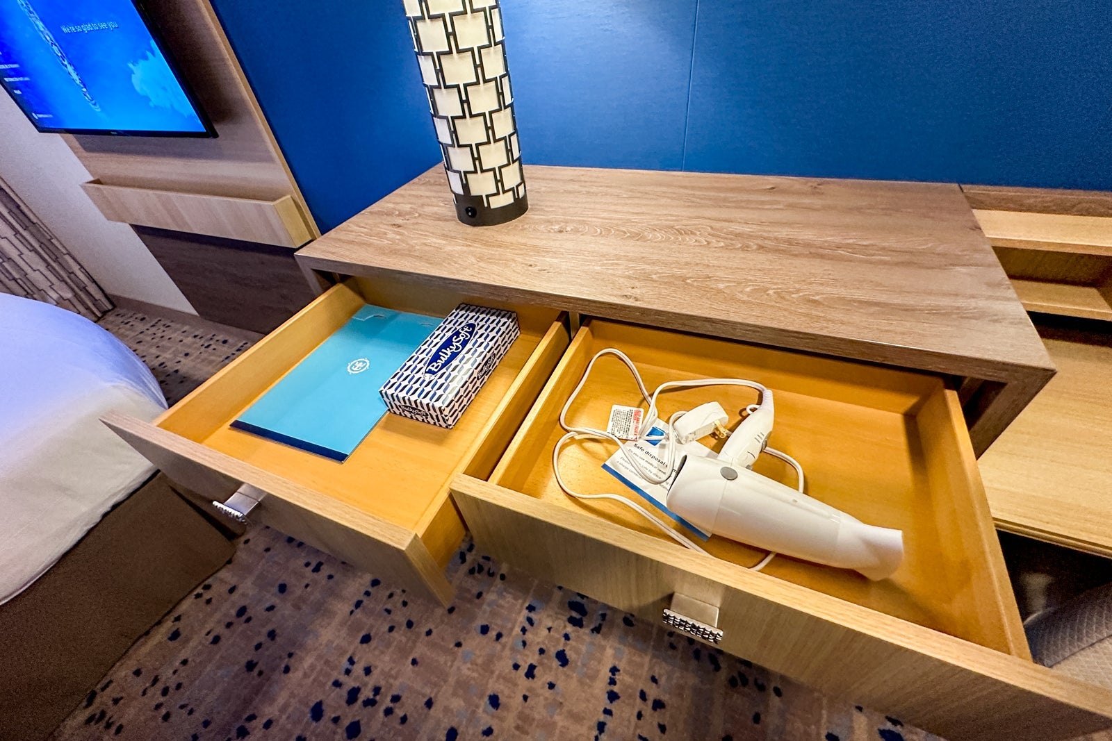 Vanity drawers with a box of tissues and a hairdryer inside