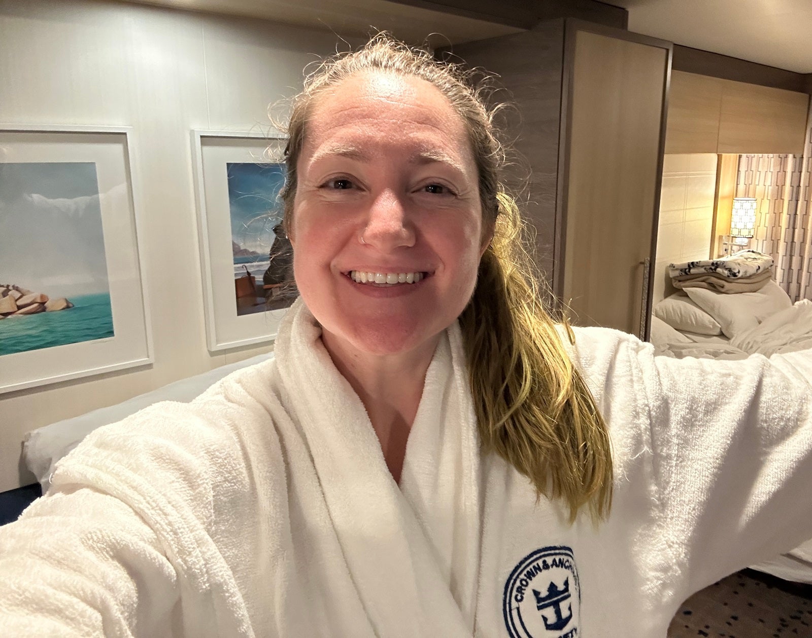 Woman in white bathrobe in a cruise ship cabin