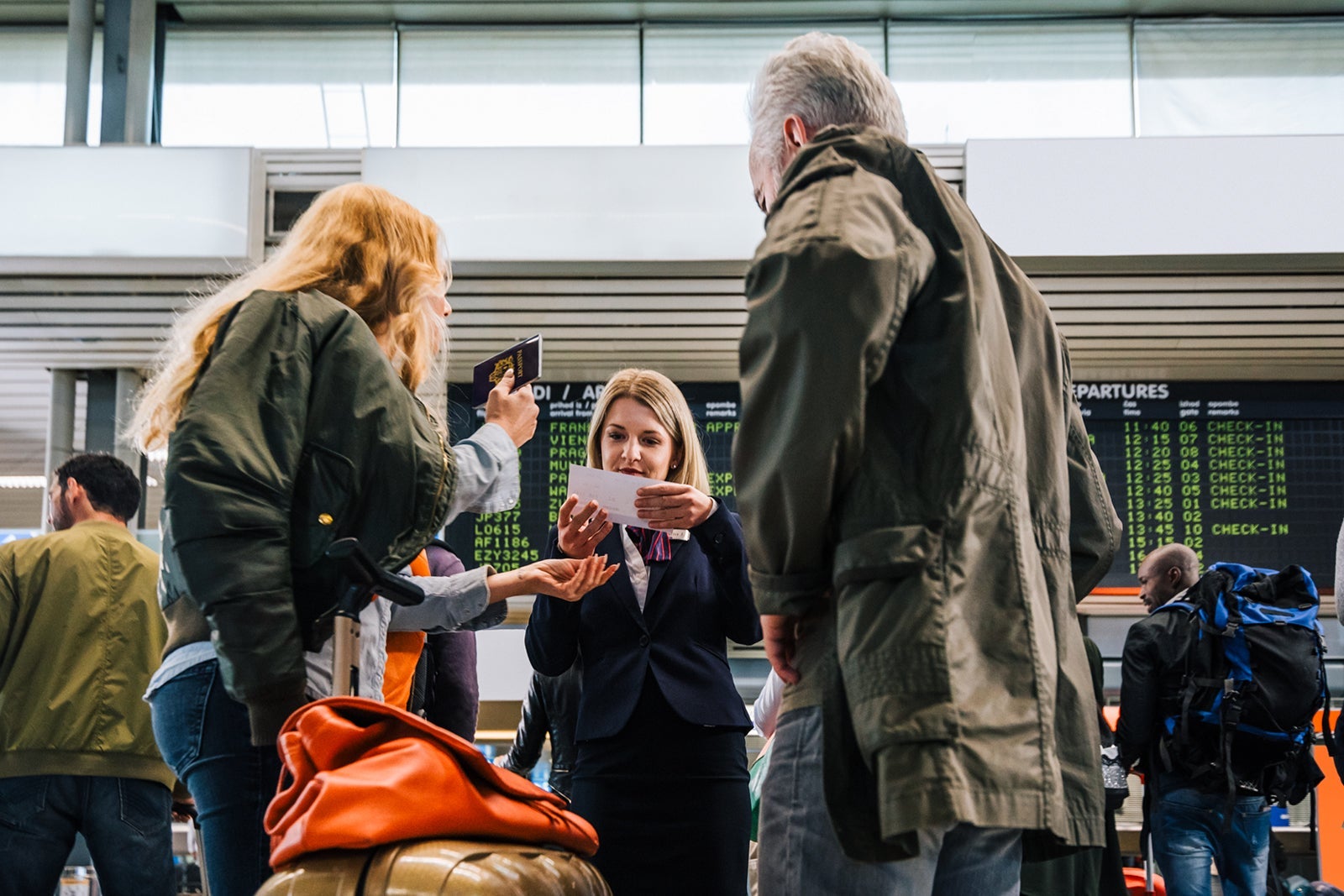 Airport Employee Helping Turists With Flights
