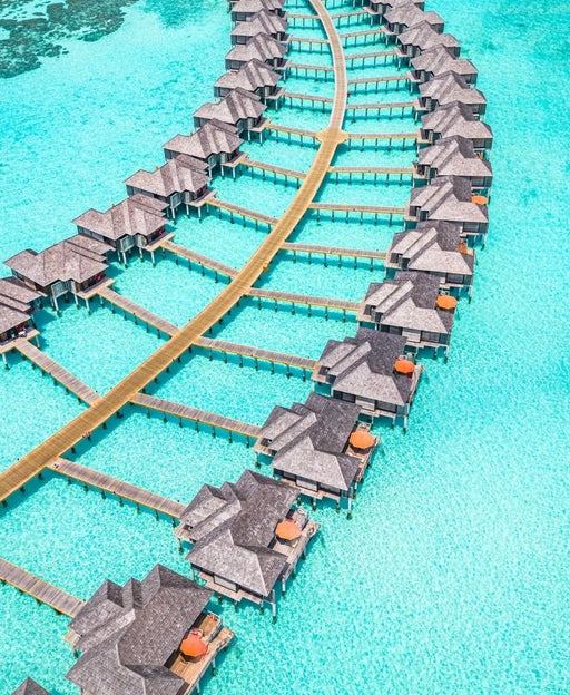 Maldives paradise scenery. Tropical aerial landscape, seascape with long jetty, water villas with amazing sea and lagoon beach, tropical nature. Exotic tourism destination banner, summer vacation