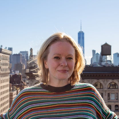 headshot of Lyndsey Matthews with NYC skyline behind her