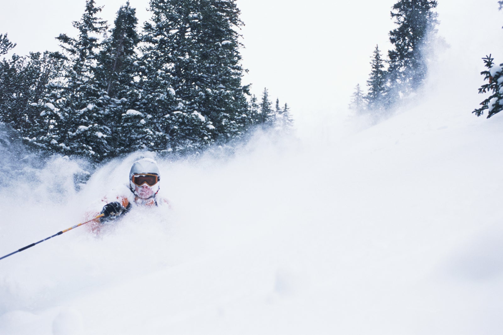 USA, Wyoming, Jackson Hole, man skiing through powder snow, winter