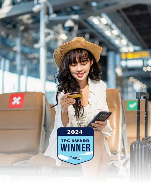 Woman using a credit card at the airport
