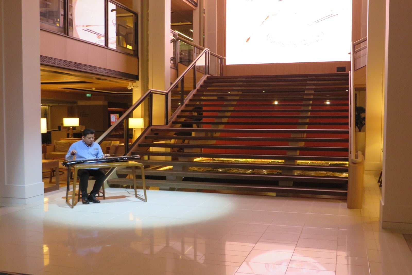 A man playing a Chinese guqin on a cruise ship
