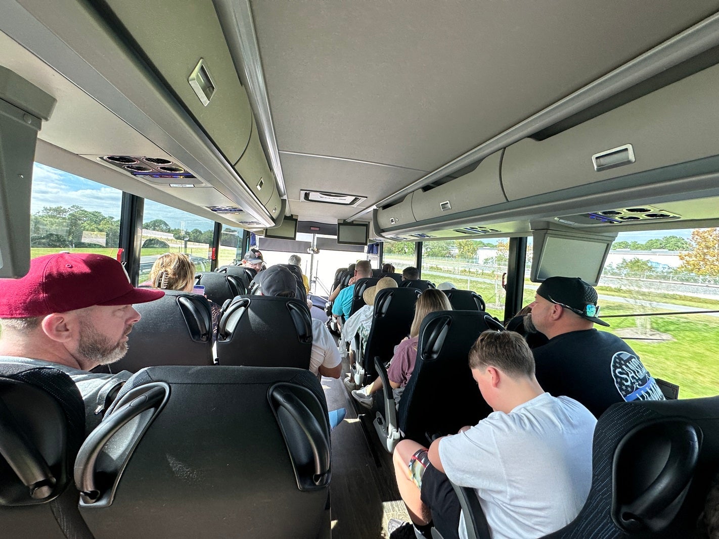 A view from inside a charter bus, facing forward