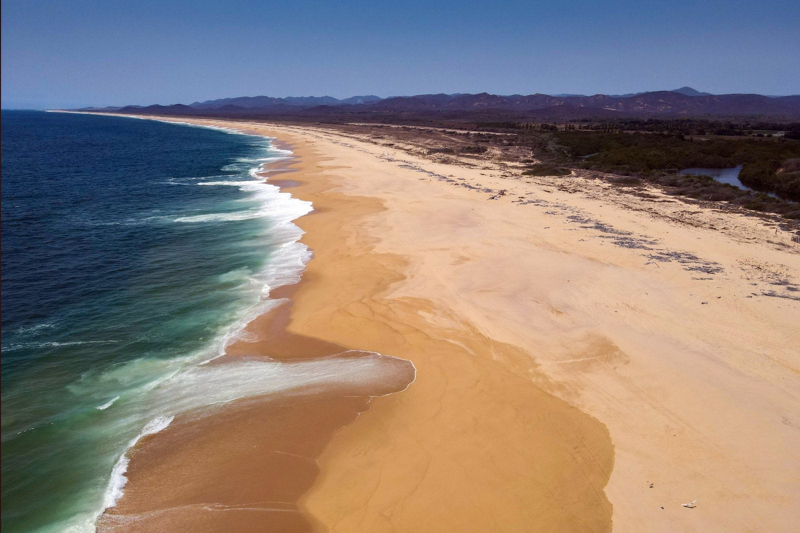 Pounding surf on Mayto Beach, Cabo Corrientes, Jalisco state, Mexico. Mayto Beach is a long usually deserted stretch of coastline that has a vicious shore break that discourages swimmers.