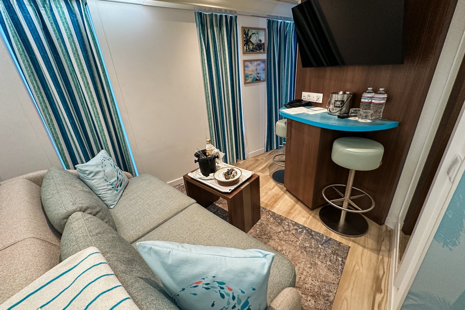 A sitting and bar area in a cruise ship cabin