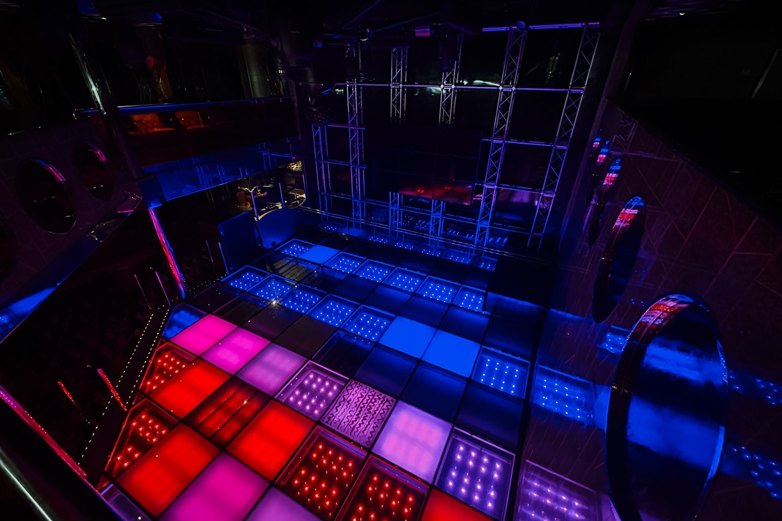 An aerial view of a light-up dance floor at a cruise ship nightclub