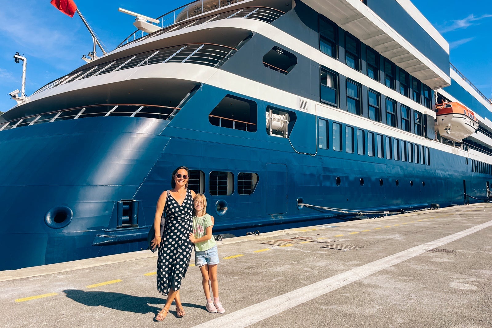 Woman and girl in front of cruise ship