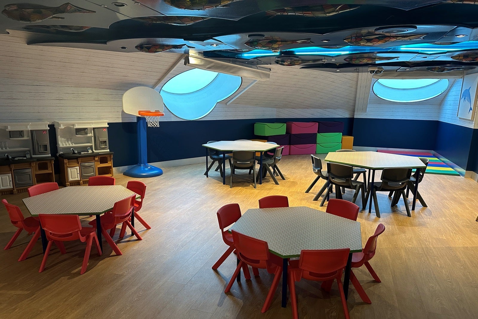 A cruise ship kids club with tables and chairs