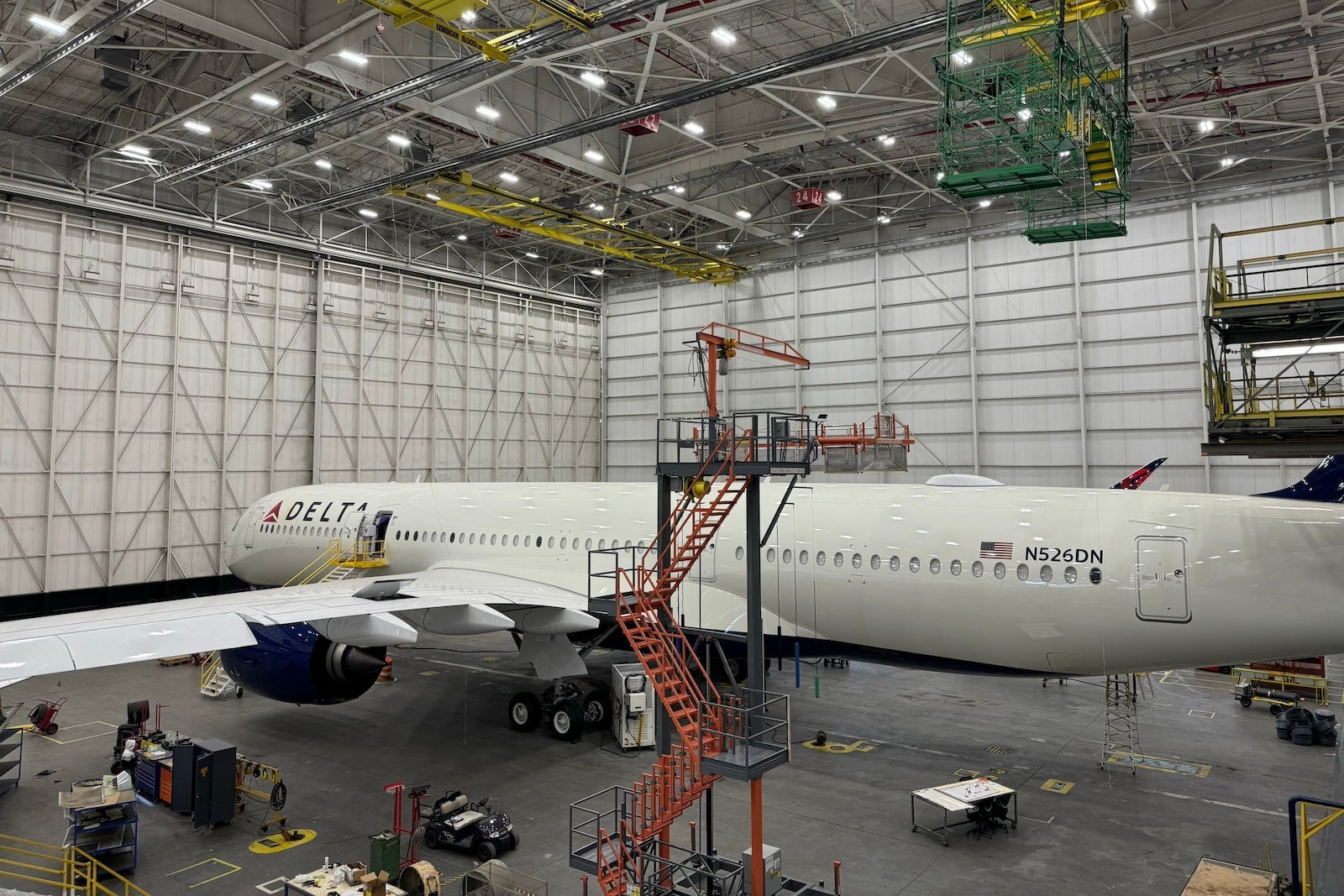 a Delta plane inside a large white hangar