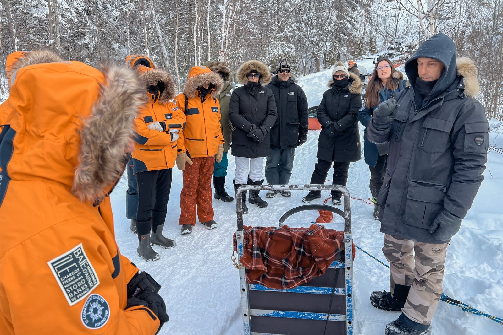 A dog sledding guide explains how to operate a dogsled