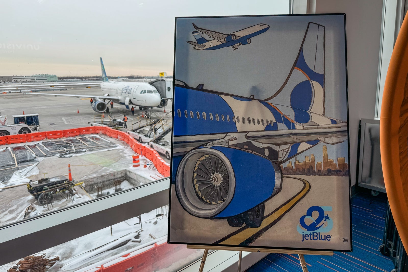 25 cities in 11 days: How this JetBlue flyer earned 350,000 points and 25 years of elite status A portrait commemorated JetBlue's 25th anniversary in February 2025 at New York's John F. Kennedy International Airport (JFK).