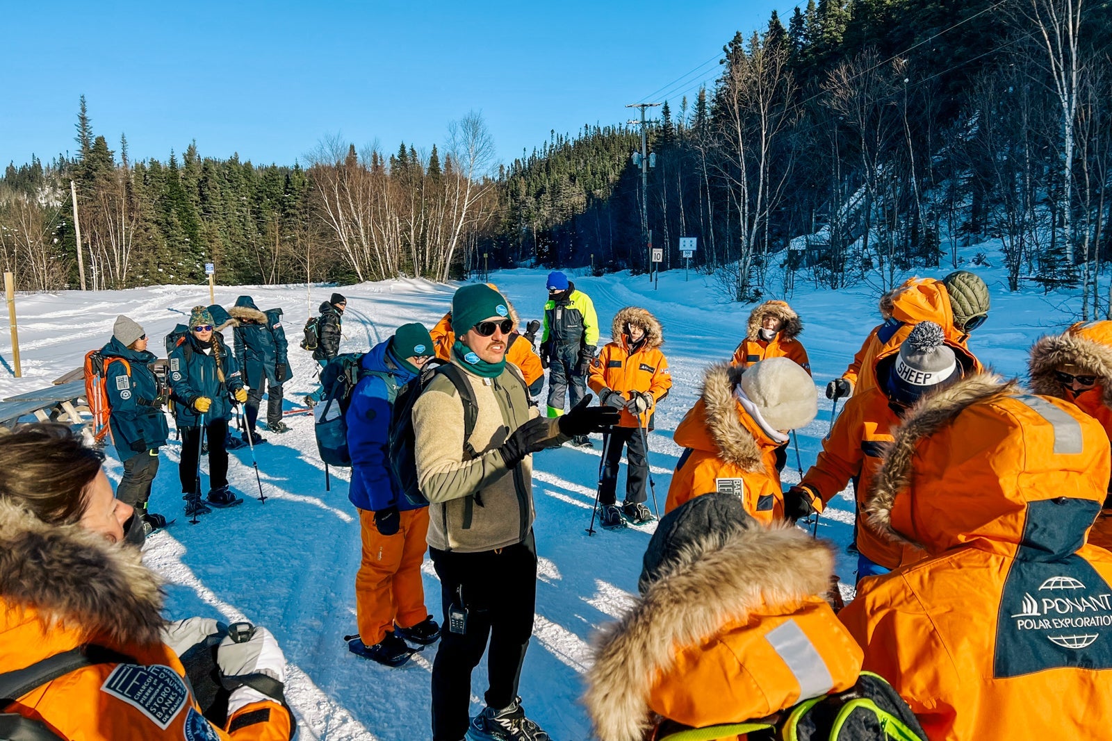 A guide explains the day's plans during a snowshoe tour near Sept-Iles, Quebec