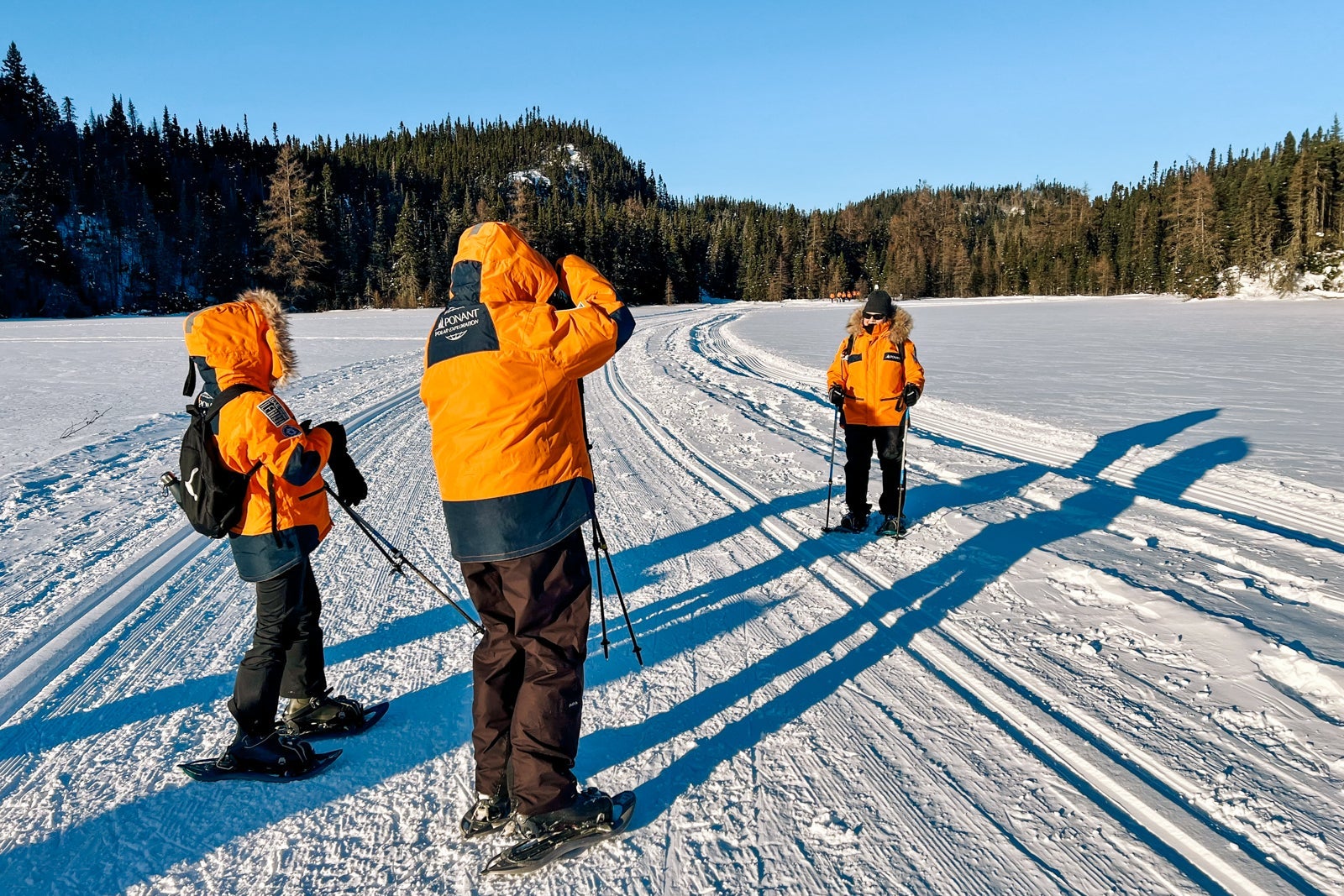 Passengers stop for photos during a snowshoe outing near Sept-Iles, Quebec