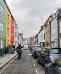 Street scene with colorful pastel apartment buildings in London's Chelsea neighborhood on a gray day in February.