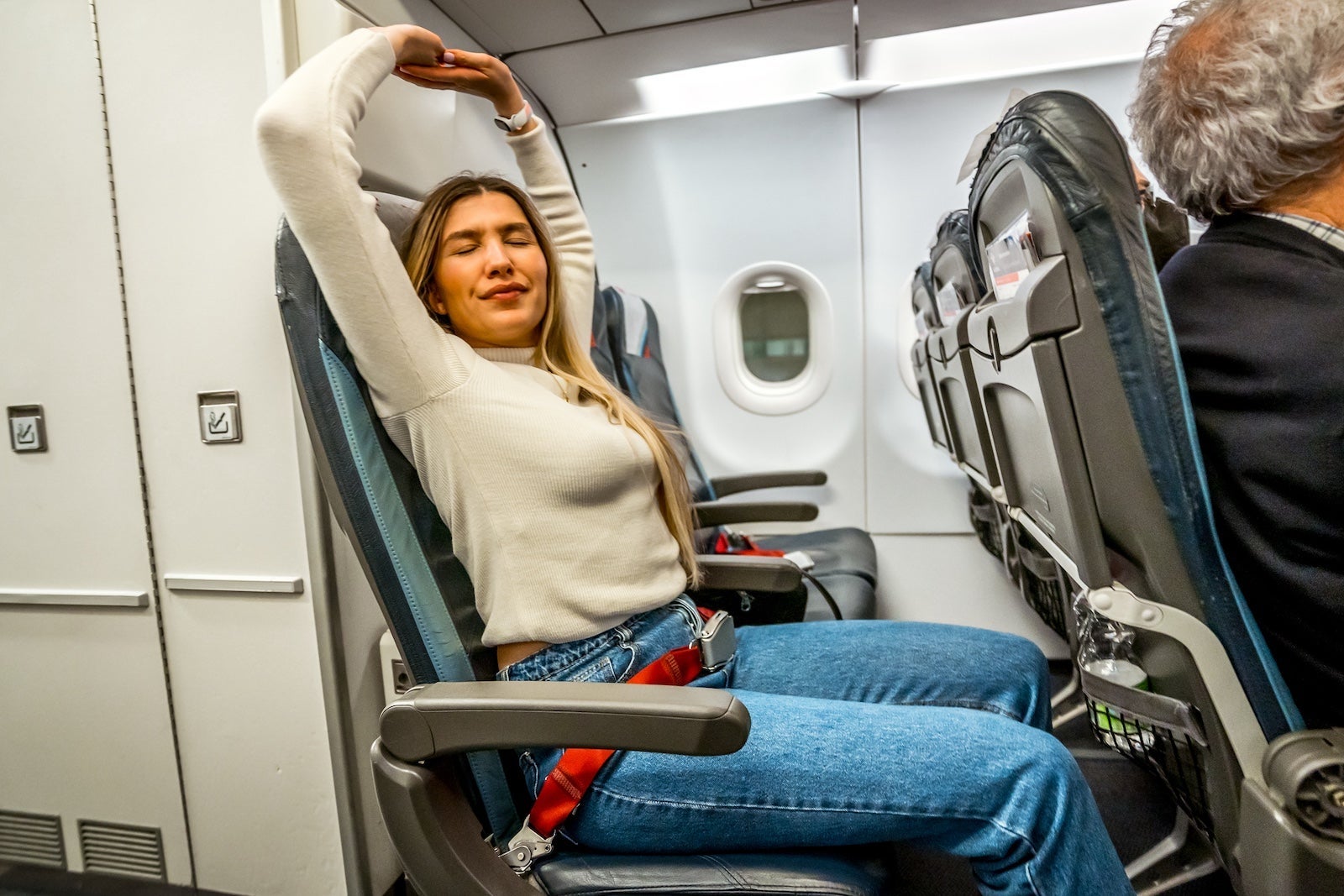 woman stretching on plane