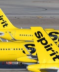 Three Spirit Airlines Airbus A320neo parked next to the terminal at Harry Reid International airpot in Las Vegas, Nevada.