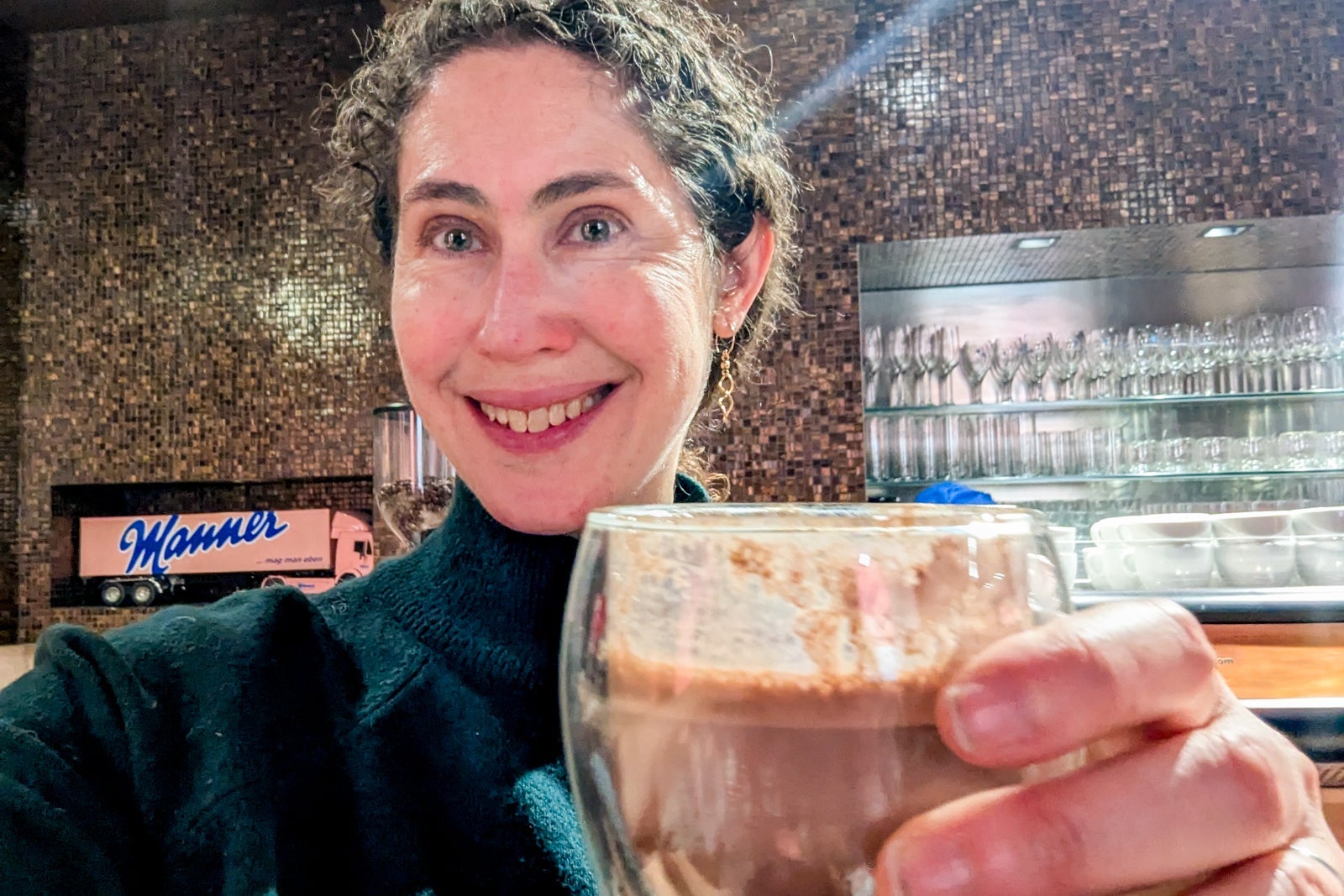 Woman holding up a cup of hot chocolate